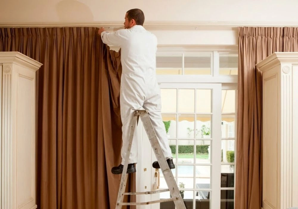 Professional worker handling neat curtain installation