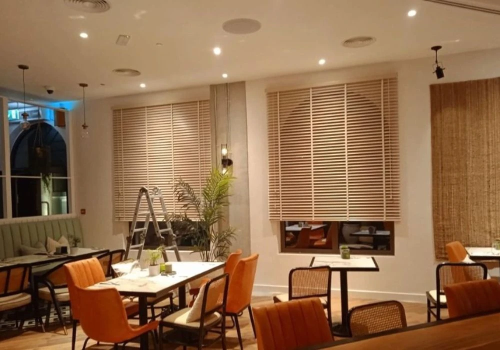 Light wooden Venetian blinds cafe interior