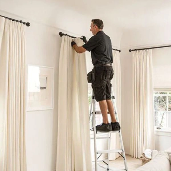 Professional ladder setup for curtain installation