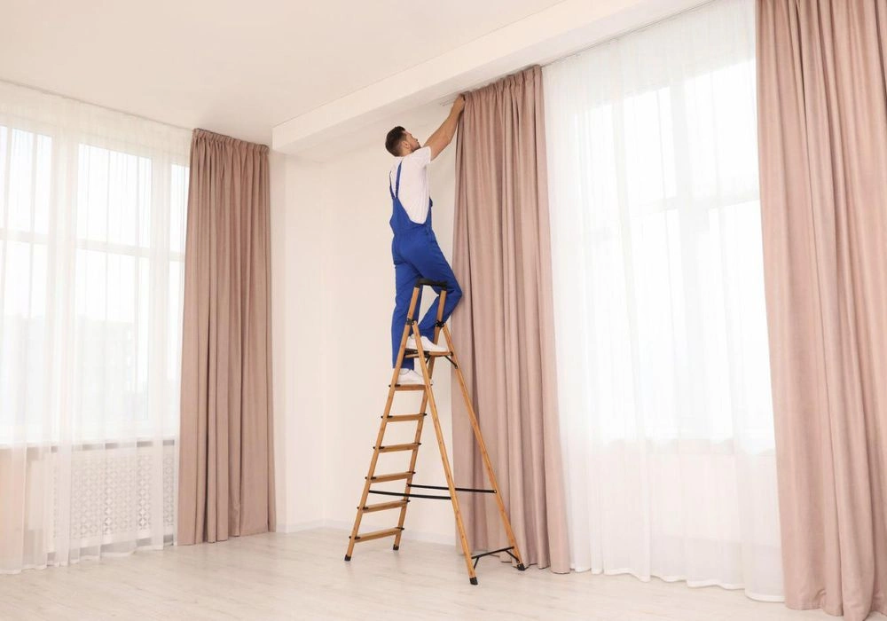 Tall ladder setup for curtain installation