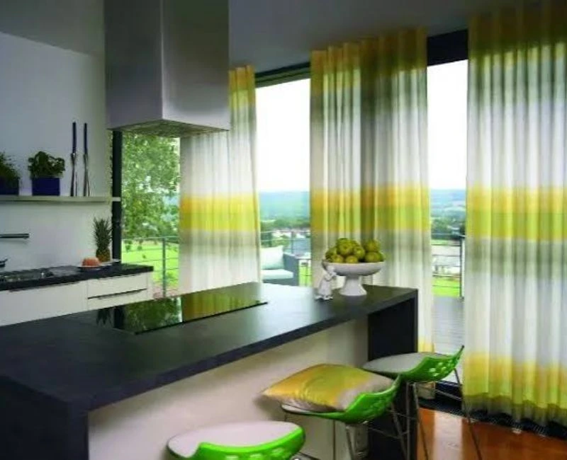 Green striped sheer curtains near counter