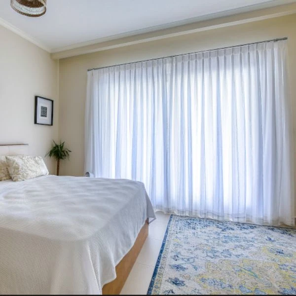 Large white sheer curtains cozy master bedroom