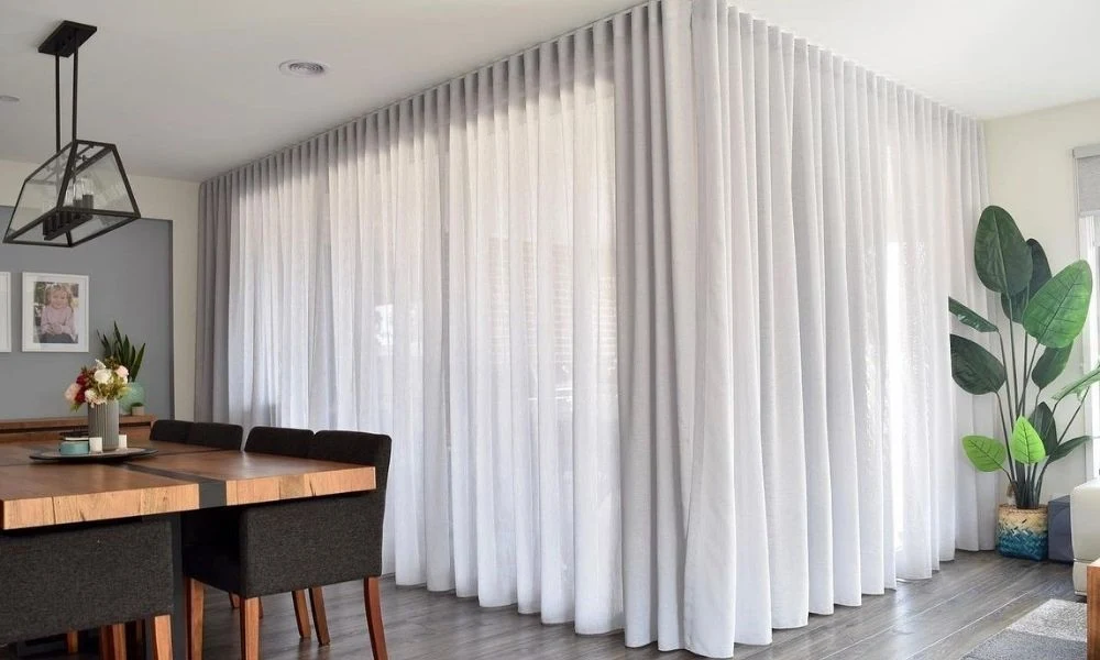 White sheer curtains partition dining room area