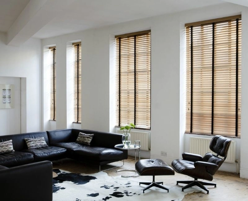 Natural wood blinds black leather sofa