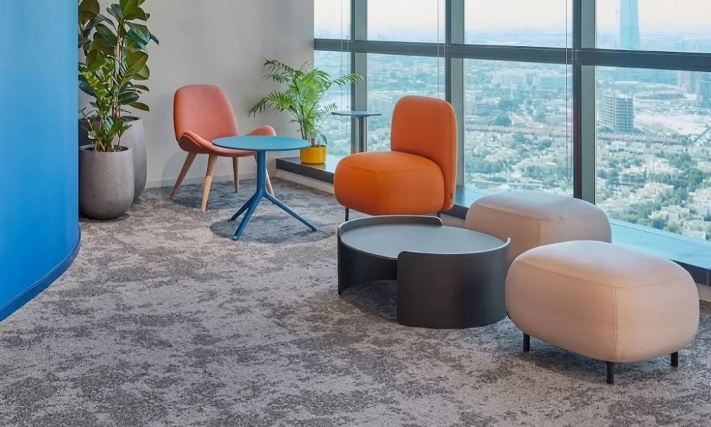 Modern office lounge with grey carpet flooring