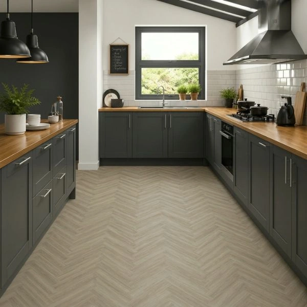 Dark grey kitchen cabinets with herringbone flooring