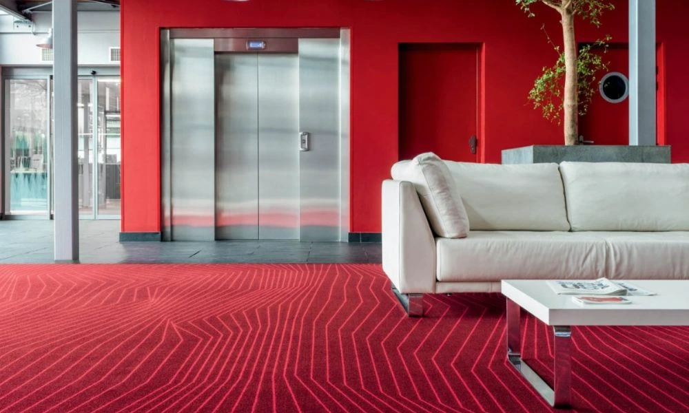 Modern lobby area with red patterned carpet