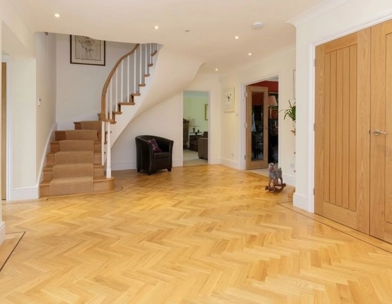 Oak herringbone hardwood floor in home hallway