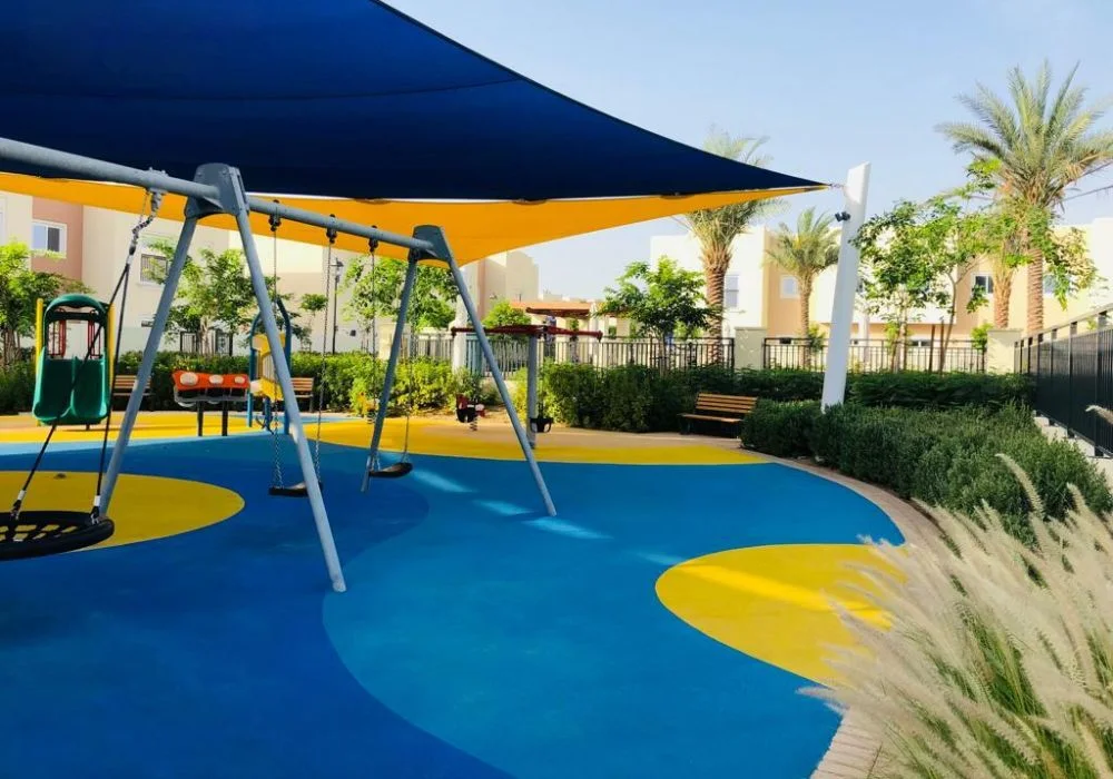 Shaded outdoor playground blue yellow EPDM floor