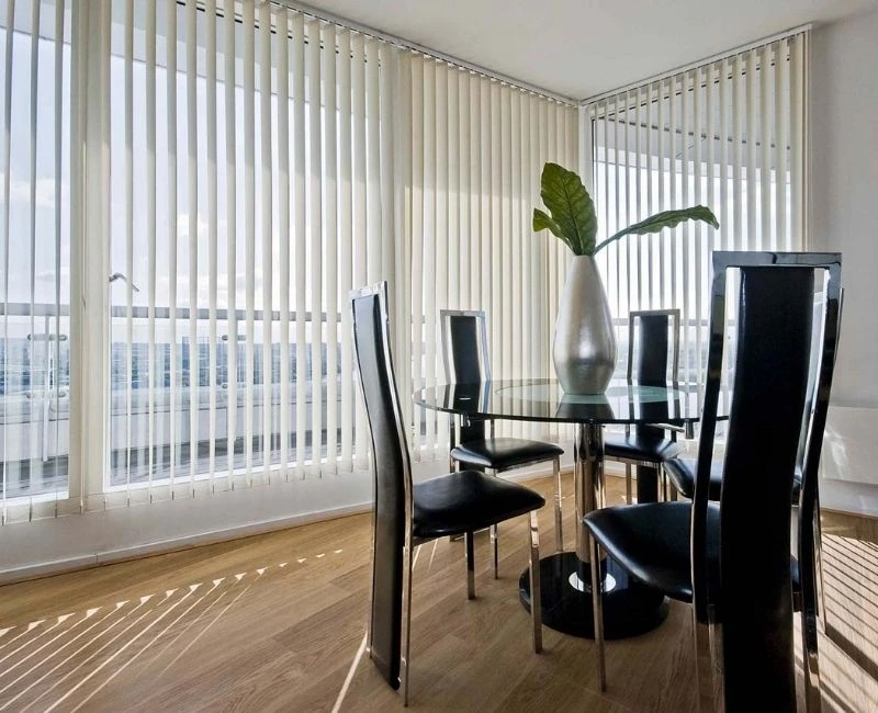White vertical blinds dining room window