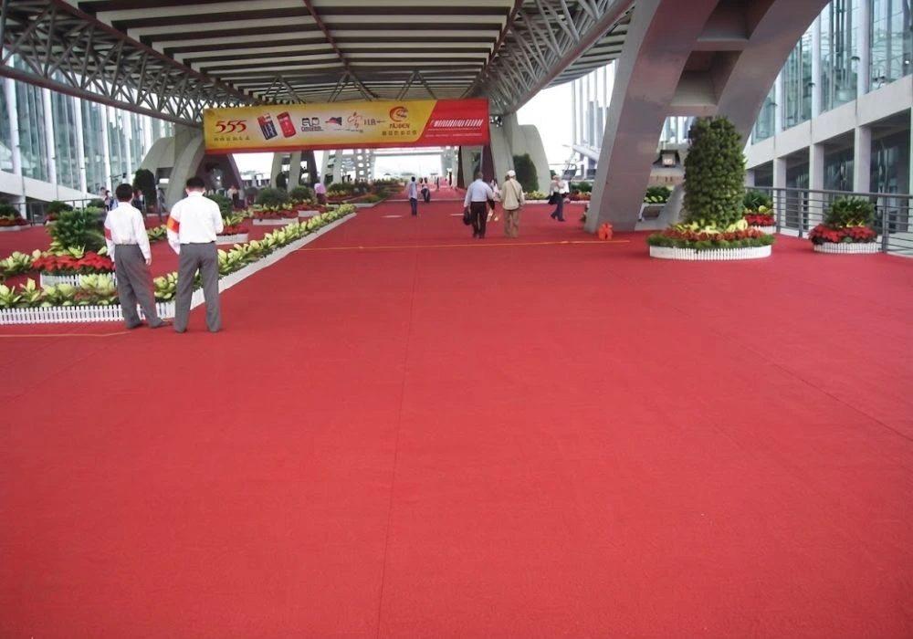 Red carpet walkway decorated with floral pillars