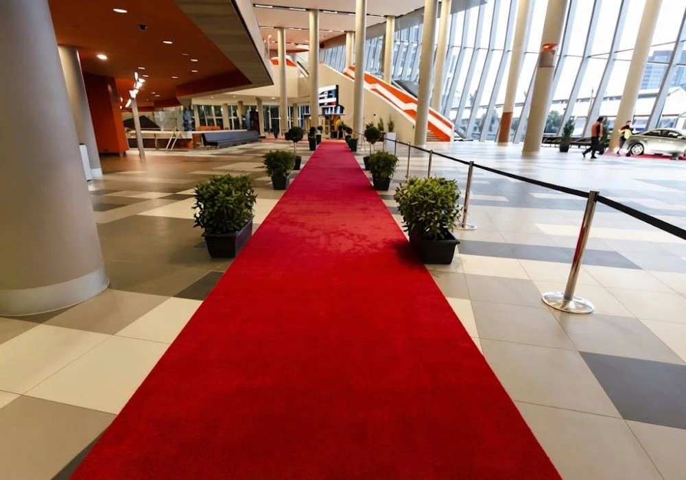 Long red carpet runner in a modern building hall