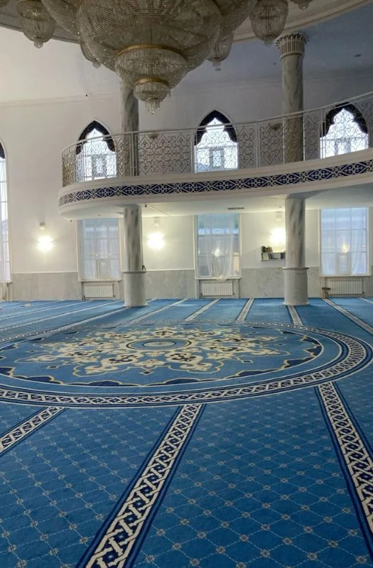 Blue patterned mosque carpet with center medallion in grand hall