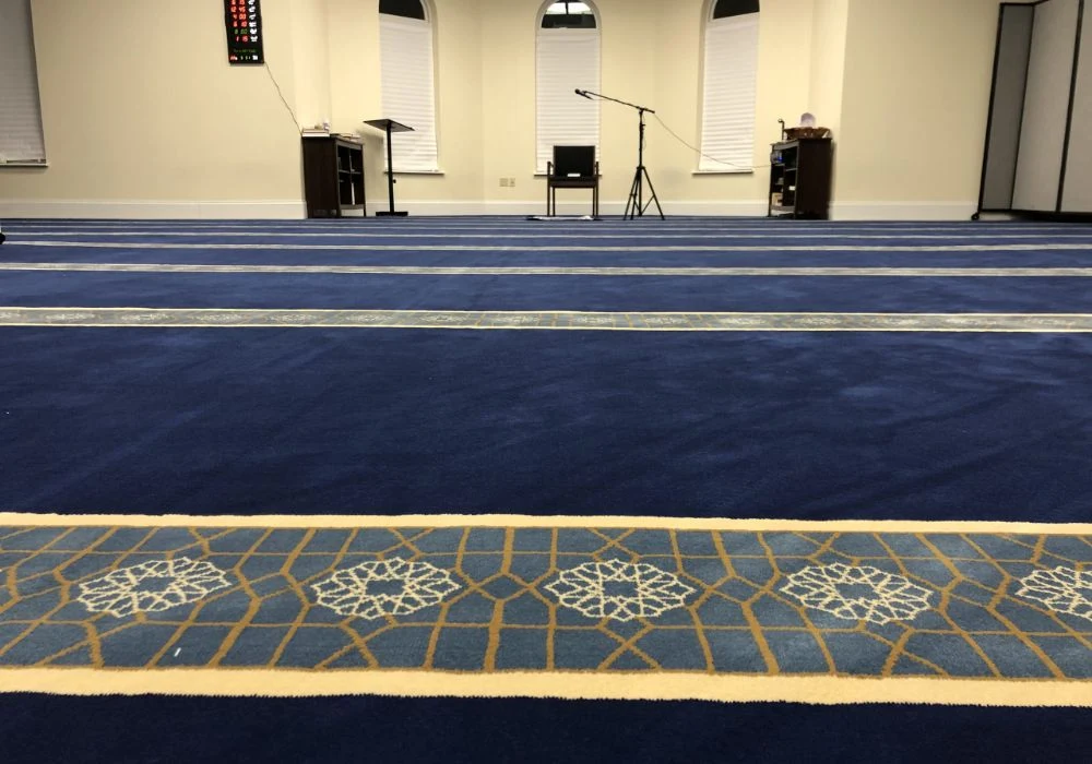 Blue mosque carpet with geometric border lines