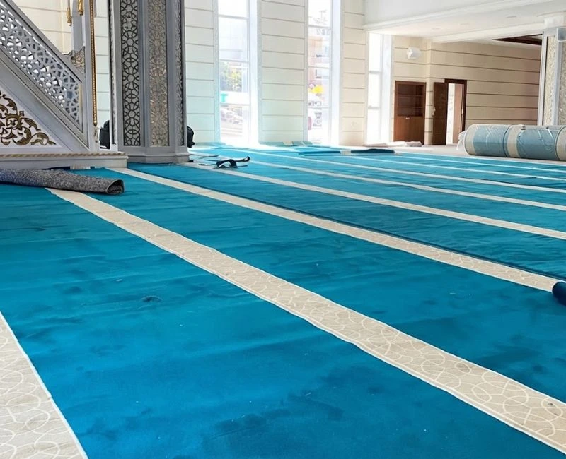 Bright blue mosque carpet installation in Dubai