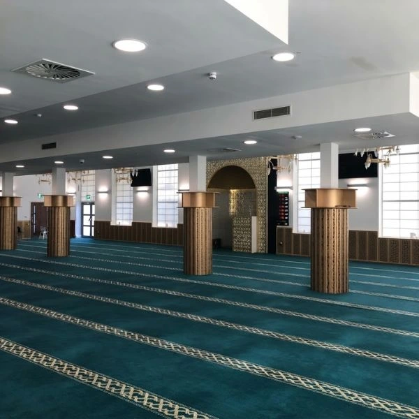 Modern blue mosque carpet installation in large hall