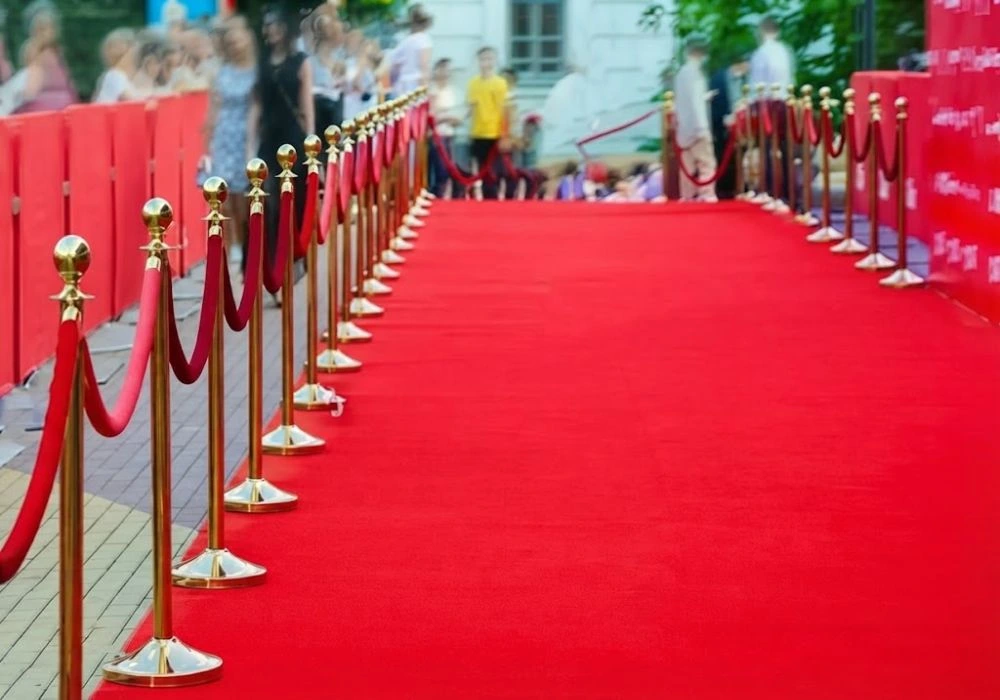 Red carpet pathway lined with gold stanchions