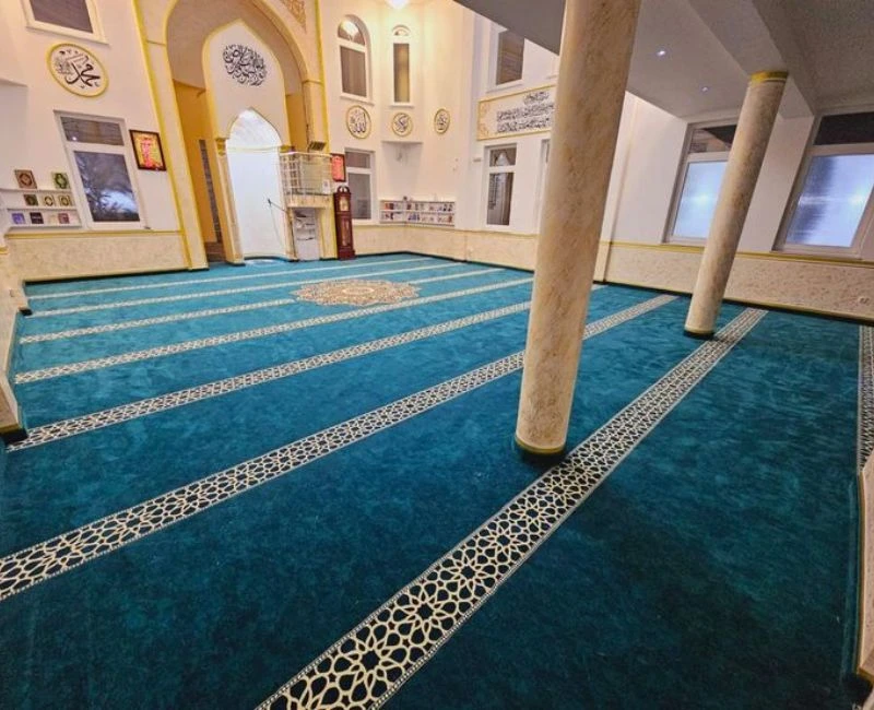 Teal mosque carpet rolls with decorative borders